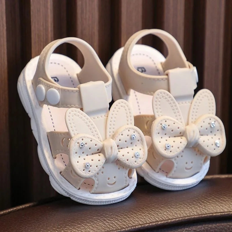 Nuevos zapatos de bebé de 0 a 3 años con bonito lazo y diamantes de imitación para niñas, sandalias antideslizantes de suela blanda para niños pequeños con dedos cubiertos